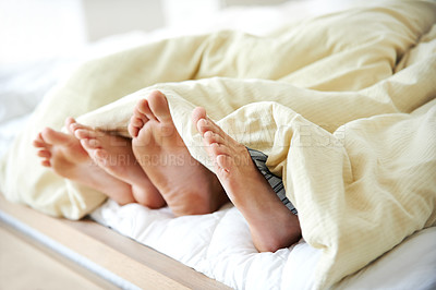 Buy stock photo Feet, couple and sleeping with blanket on bed for morning peace, dream and bonding together of romance. People, toes and mattress for weekend nap, partner comfort and relationship support at house