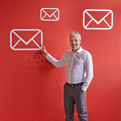 Buy stock photo Mature, happy man and portrait with email, app or envelope for communication, message or online service. Senior, businessman or employee pointing with smile, icon or symbol for presentation on wall