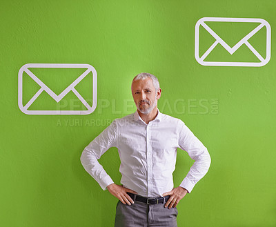Buy stock photo Portrait of a mature businessman standing against a green background with message symbols on it