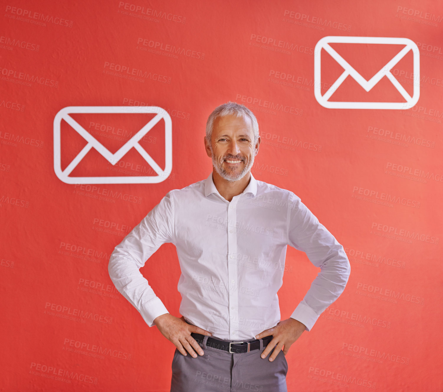 Buy stock photo Portrait of a mature businessman standing against a red background with message symbols on it