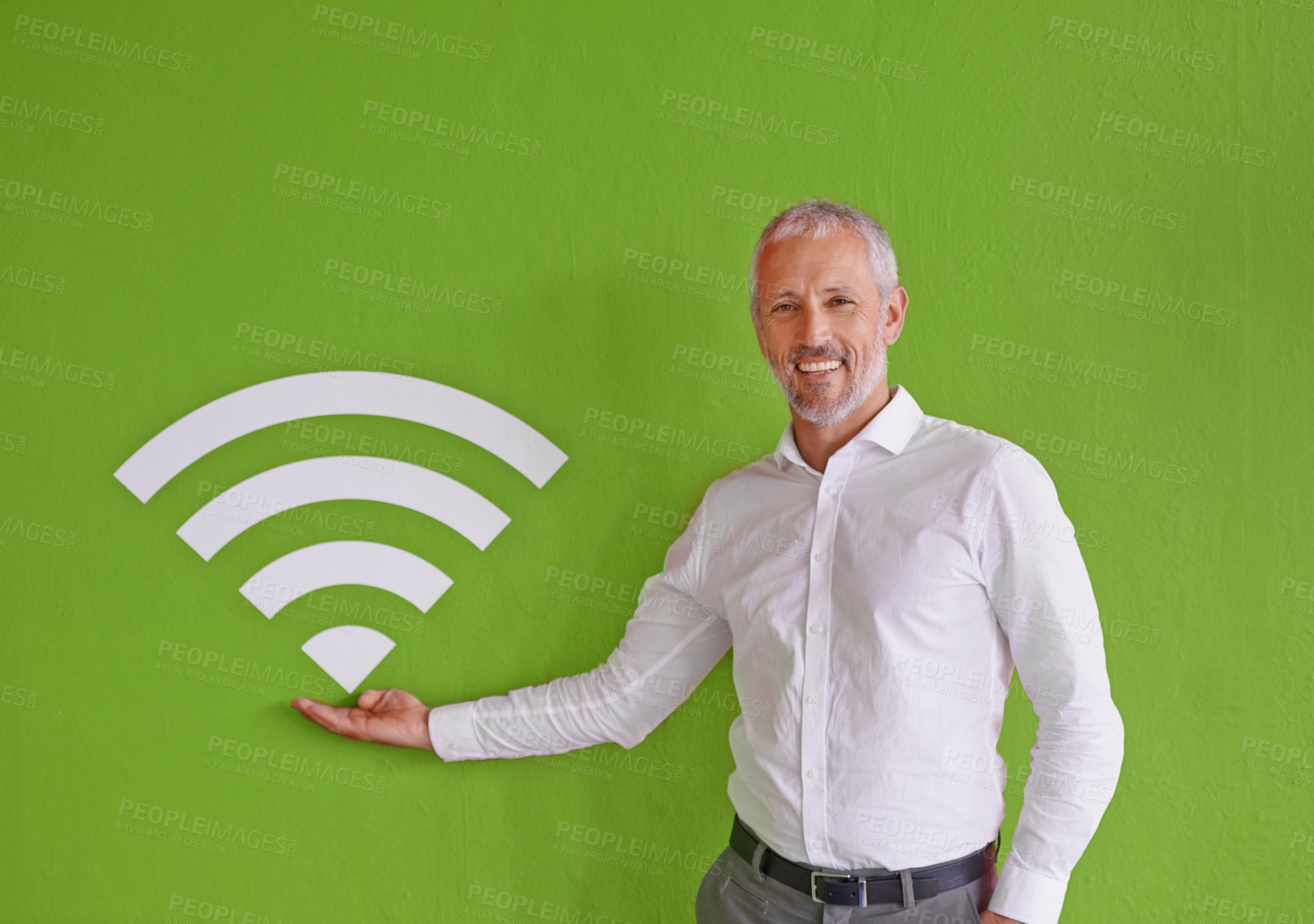 Buy stock photo Businessman, wall and sign for wireless internet with portrait, smile and choice by green background. Mature person, excited and presentation for symbol, icon or review at company for fast connection