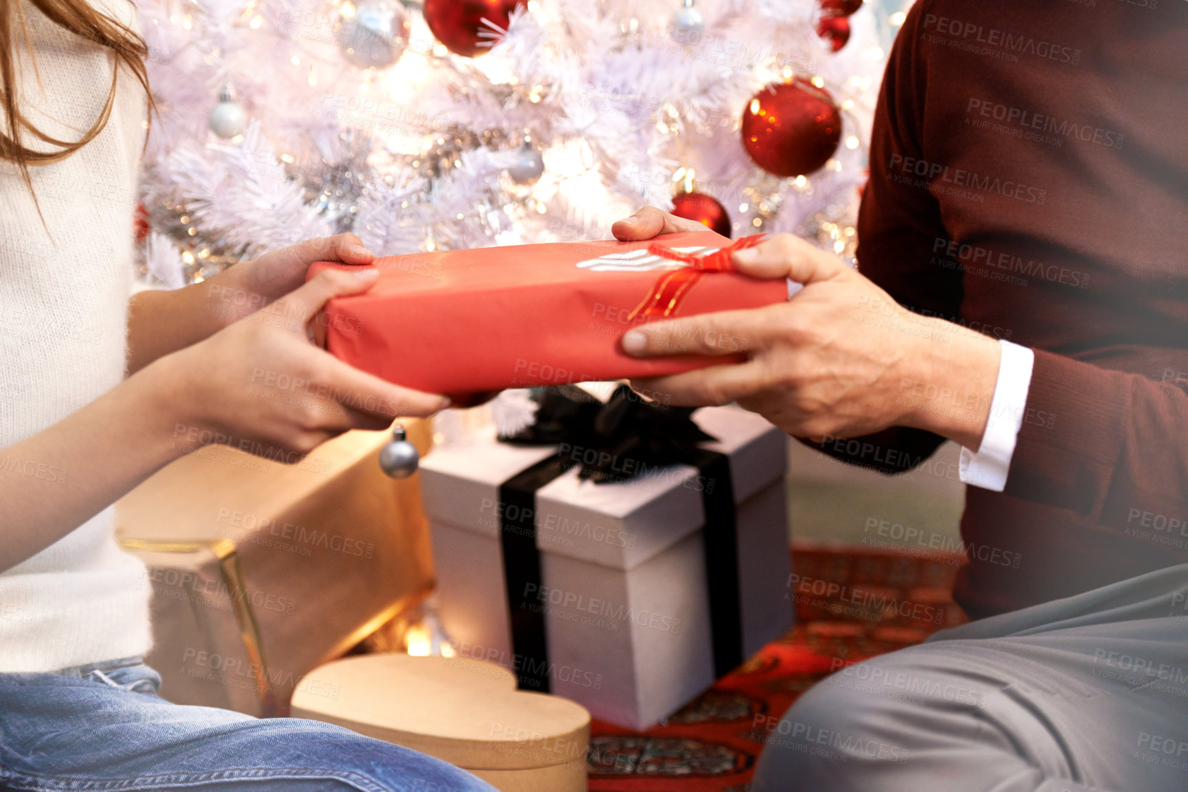 Buy stock photo Hands, Christmas gift and woman with father for festive celebration together at family home. Surprise, giving and female person with xmas present box for senior dad with holiday decorations at house.