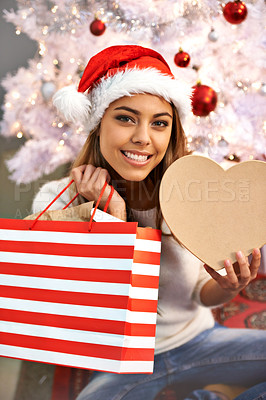 Buy stock photo Portrait of a beautiful young woman sitting with her Christmas presents