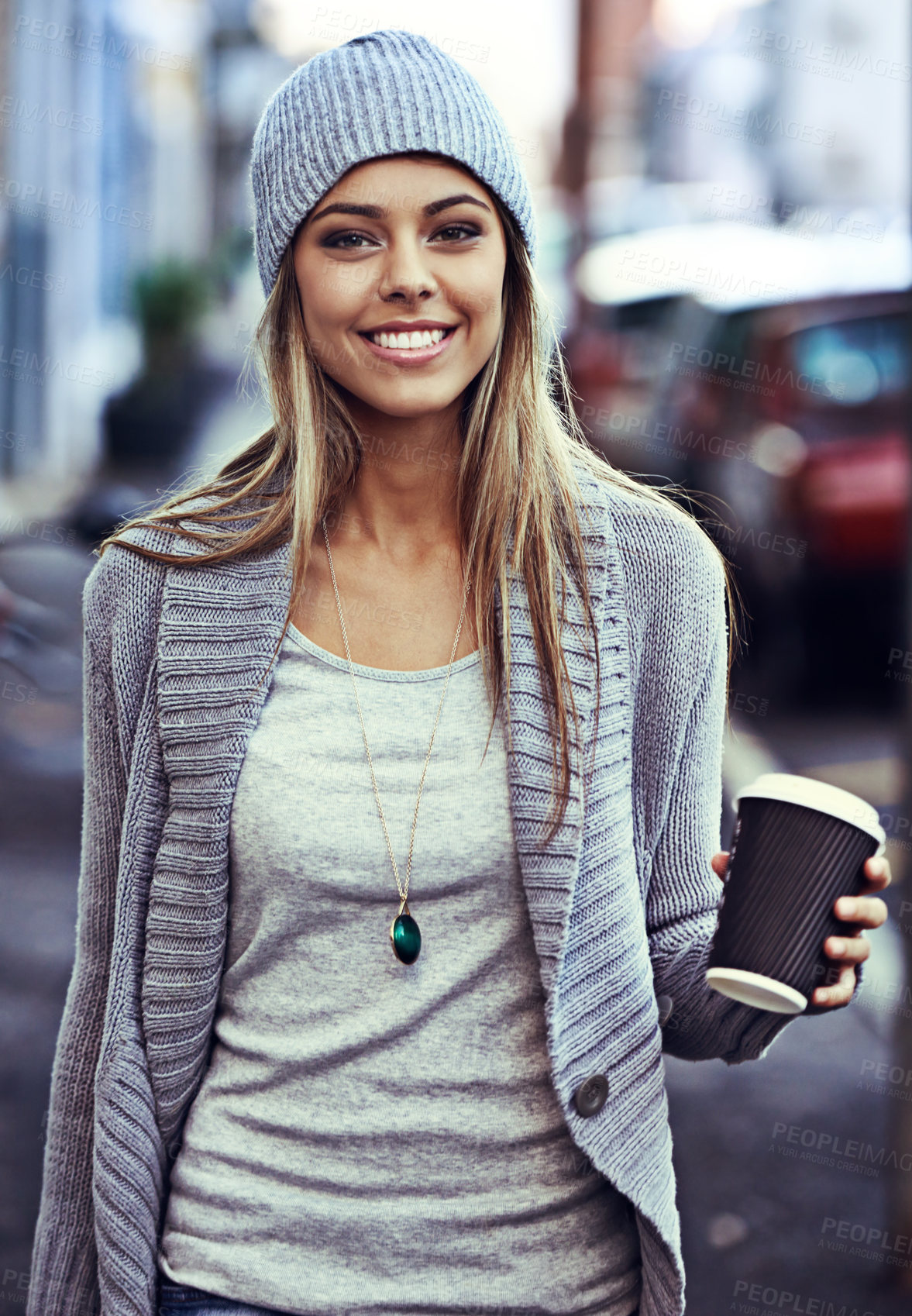 Buy stock photo Portrait of a beautiful young woman walking with a takeaway coffee in the city