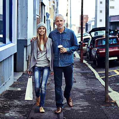 Buy stock photo Portrait of a father and daughter walking together in the city with their shopping and takeaway coffee