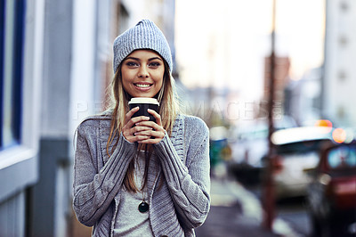 Buy stock photo Portrait of a beautful young woman standing with a takeaway coffee in the city