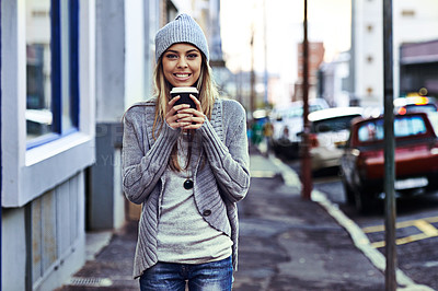 Buy stock photo Portrait of a beautful young woman standing with a takeaway coffee in the city