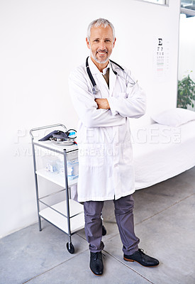 Buy stock photo Full length portrait of a handsome mature doctor standing in a hospital room