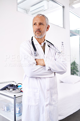 Buy stock photo Doctor, thinking and confident in hospital for healthcare, friendly service and pride. Mature man, medical worker and arms crossed in office with ideas for future in career in government institute