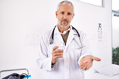 Buy stock photo Mature, doctor and portrait with pills or water for prescription medication, healthcare treatment and supplements. Physician, man and medicine in clinic to drink pharmaceuticals for health recovery