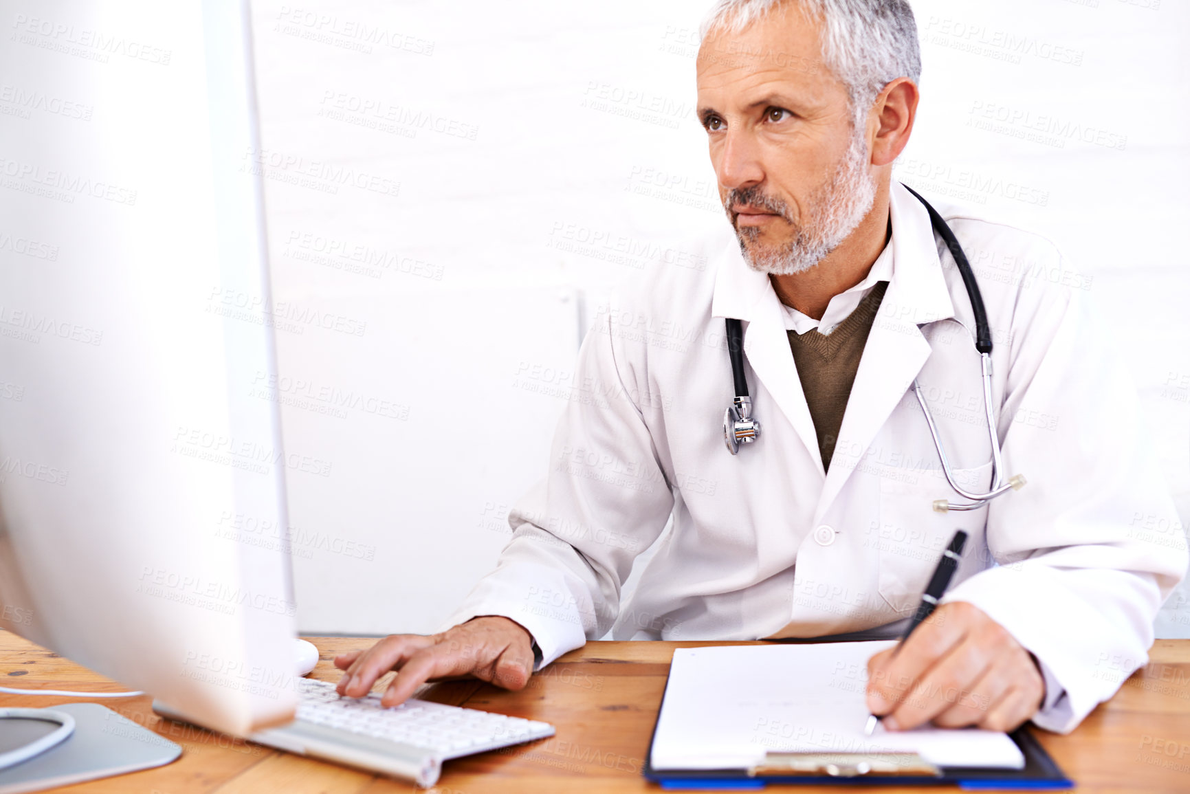 Buy stock photo Computer, telehealth and healthcare with man in hospital for scan, medical or ai tumour detection. Medicine, insurance and research with mature doctor and clipboard for online or disease screening