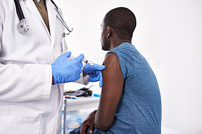 Buy stock photo Cropped shot of a male doctor giving his patient an injection