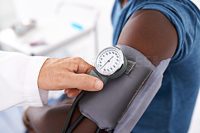 Buy stock photo Closeup shot of a doctor measuring a patient's blood pressure