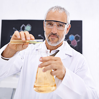 Buy stock photo Portrait of a mature male scientist conducting an experiment in his lab