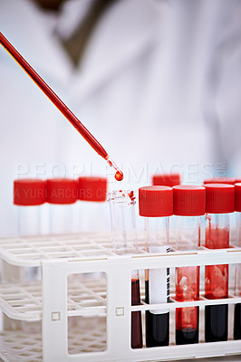 Buy stock photo Cropped shot of a scientist working with blood samples in the lab