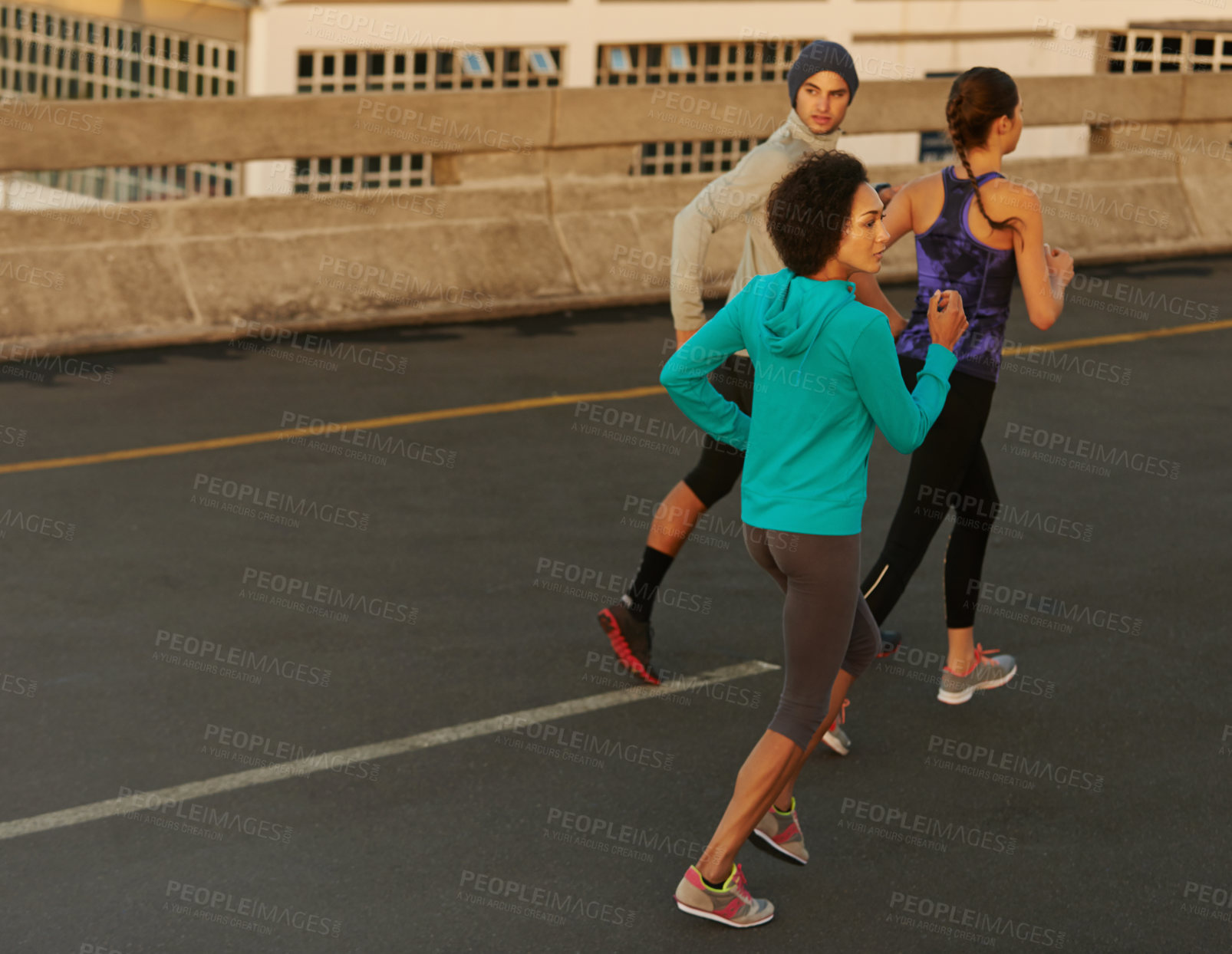 Buy stock photo Workout, city and people running on bridge together for sports training, commitment and body health. Evening, exercise and group of friends on road for urban fitness with outdoor challenge on street