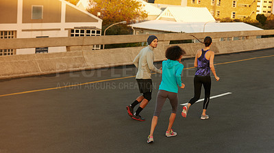 Buy stock photo Urban, workout and people running on street together for sports training, commitment and body health. Evening, exercise and group of friends on road for city fitness with outdoor wellness challenge