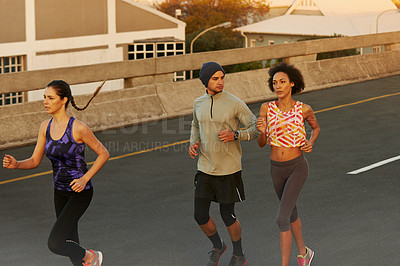 Buy stock photo Fitness, people and running with group on street in city for workout, training or outdoor exercise together. Active, young runners or team in race for cardio or practice on road in health or wellness