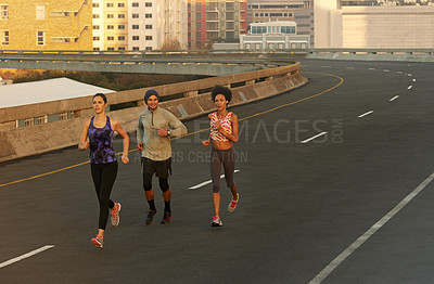 Buy stock photo Urban, workout and people on street running together for sports training, commitment and body health. Evening, city and group of friends on road for fitness, exercise or outdoor wellness challenge