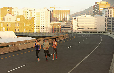 Buy stock photo Urban, exercise and people on street running together for sports training, commitment and body health. Evening, city and group of friends on road for fitness, workout or outdoor wellness challenge