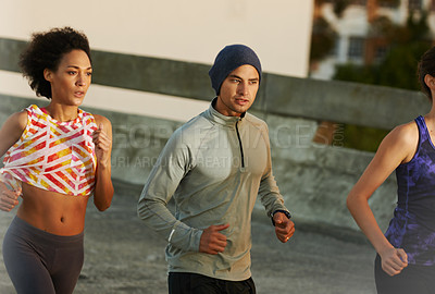 Buy stock photo Fitness, people and running with group on road in city for workout, training or outdoor exercise together. Active, young runners or action for run, cardio or practice on street in health or wellness