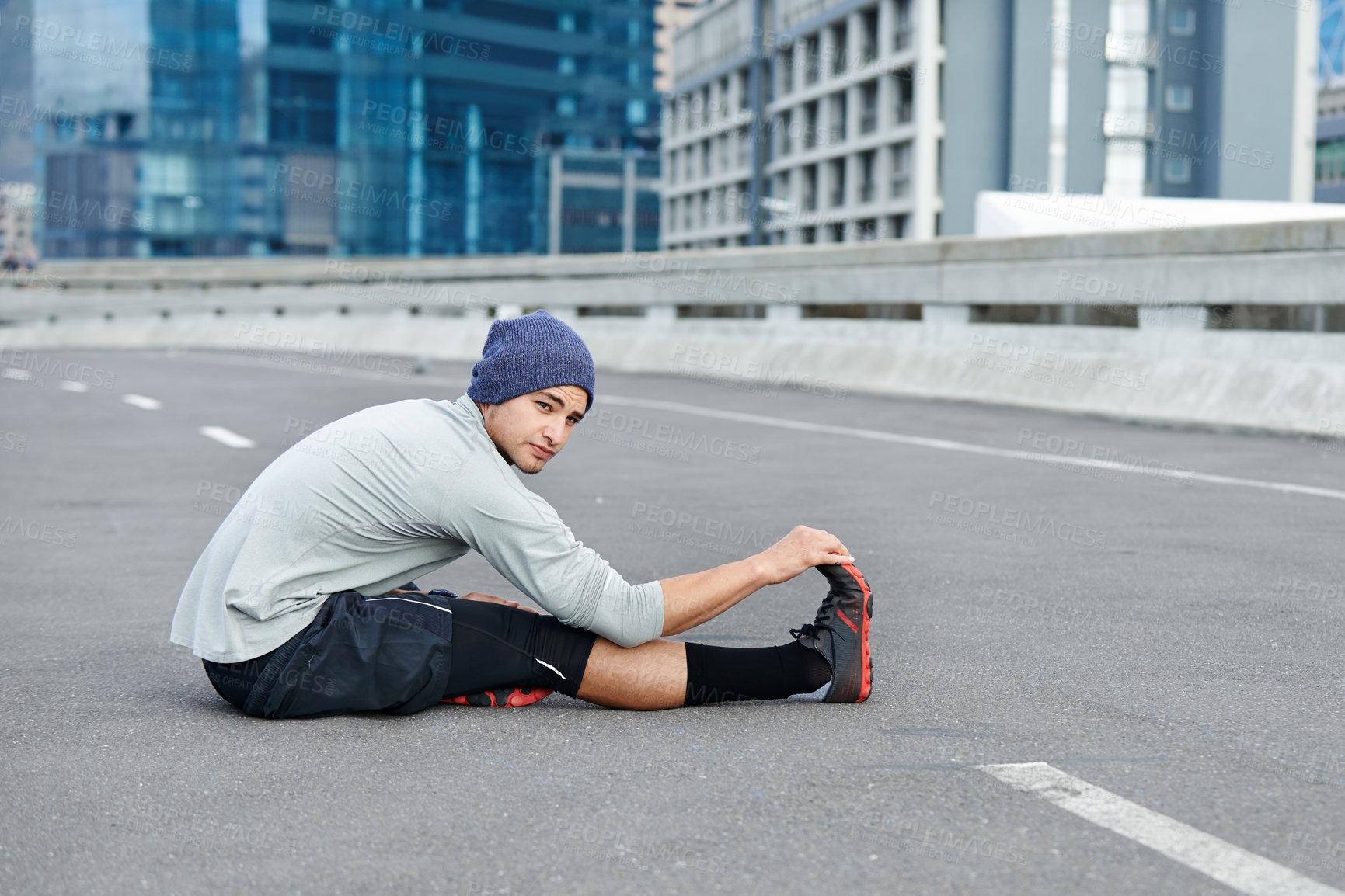 Buy stock photo Man, city and stretching legs for fitness on street, bridge challenge and morning for cardio workout. Male person, warm up and urban town for muscle relief, outdoor and athlete for start of training