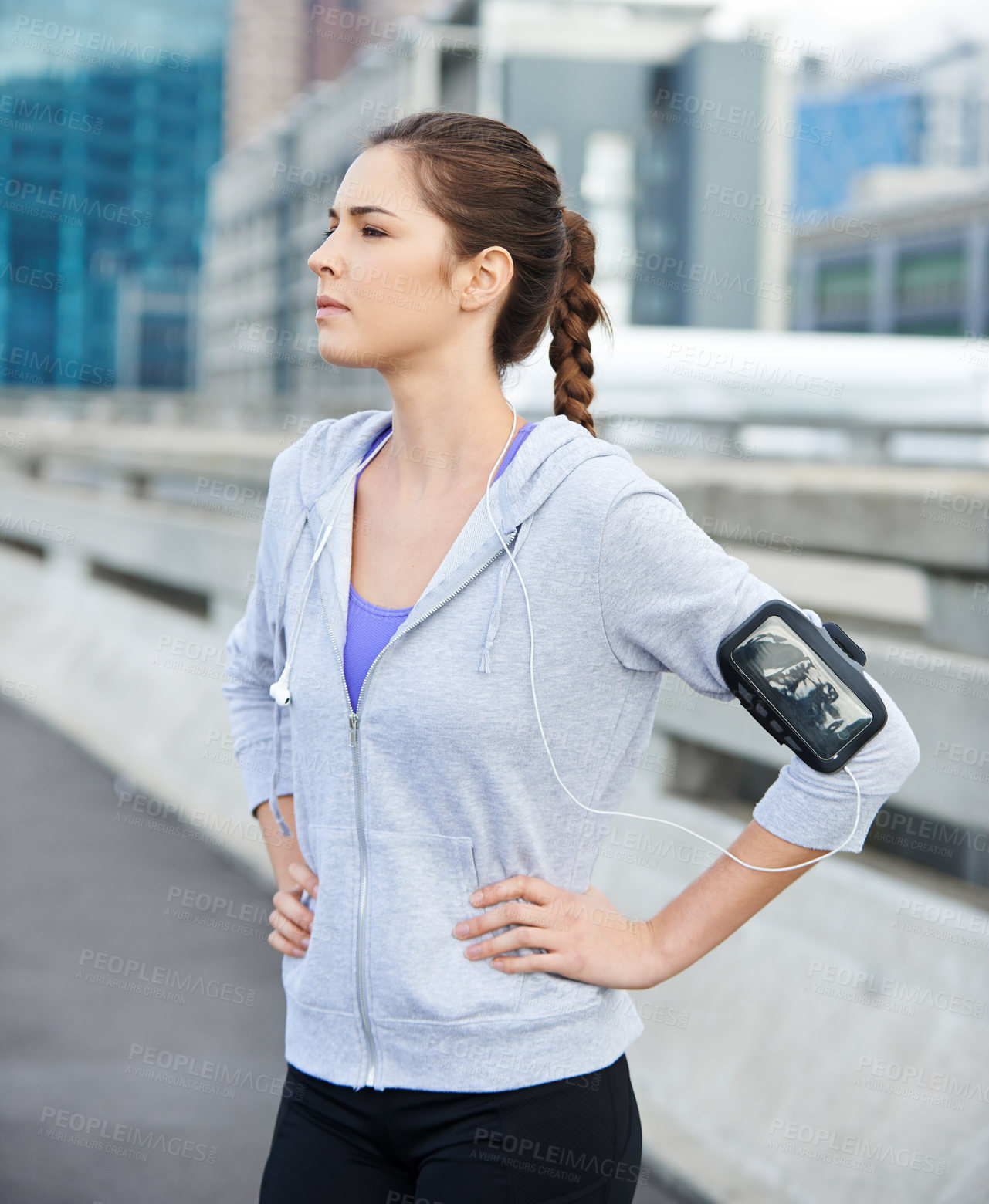 Buy stock photo Thinking, earphones and woman in city for fitness, running or workout on bridge with music. Sports, arm band and female athlete with audio tech for listening to podcast on cardio training in town.