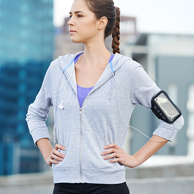 Buy stock photo Thinking, earphones and woman in city for exercise, running or workout on bridge with music. Fitness, arm band and female athlete with audio tech for listening to podcast on cardio training in town.