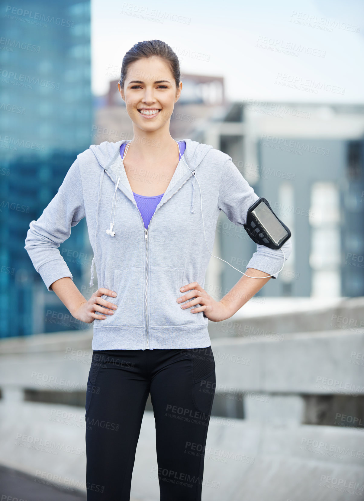 Buy stock photo Portrait, earphones and woman in city for fitness, running or workout on bridge with music. Sports, arm band and female athlete with audio tech for listening to podcast on cardio training in town.