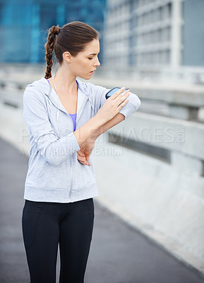 Buy stock photo Running, phone and check with woman in city for training, heart rate and wellness app. Health, exercise and marathon workout with runner on road for speed, cardio and sports performance tracker