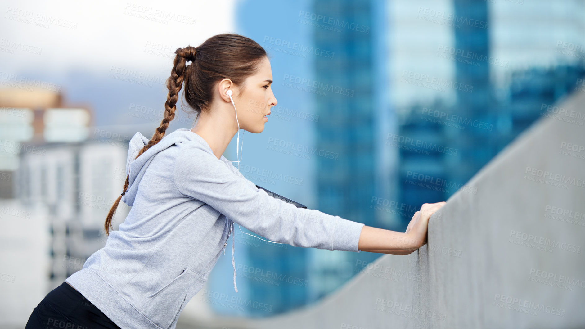 Buy stock photo Woman, city audio and warm up for exercise, bridge challenge and earphones for cardio workout. Female person, stretching and urban town for muscle relief, outdoor and athlete for start of training