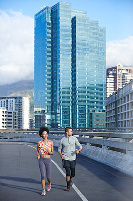 Buy stock photo Road, marathon and couple with running for fitness, endurance and health benefits with training in city. Bridge, man and woman with support for cardiovascular exercise, burn calories and wellness