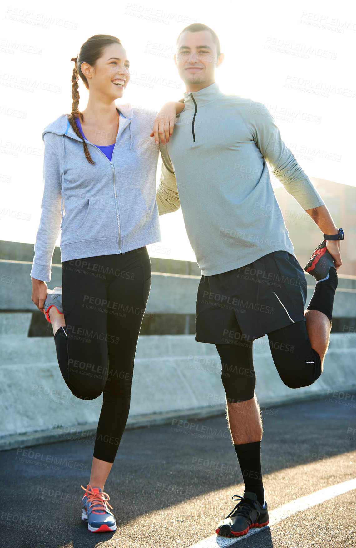 Buy stock photo Happy couple, stretching and road with fitness for workout preparation, exercise or training together in city. Man, woman and runners enjoying warm up or getting ready for running in an urban town