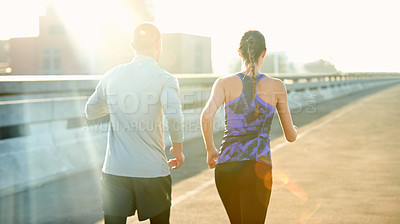 Buy stock photo People, couple and running on road for fitness with training, support and care in California. Back, exercise and workout with jogging for health or wellness and wellbeing in sportswear in lens flare