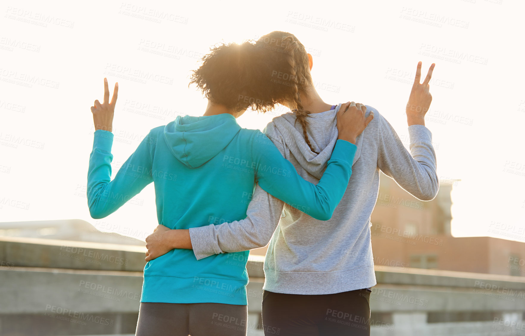 Buy stock photo Women, fitness and back with hug or peace sign in city workout or outdoor exercise together. Young, female person or friends with emoji, gesture or hand symbol for health or wellness in an urban town