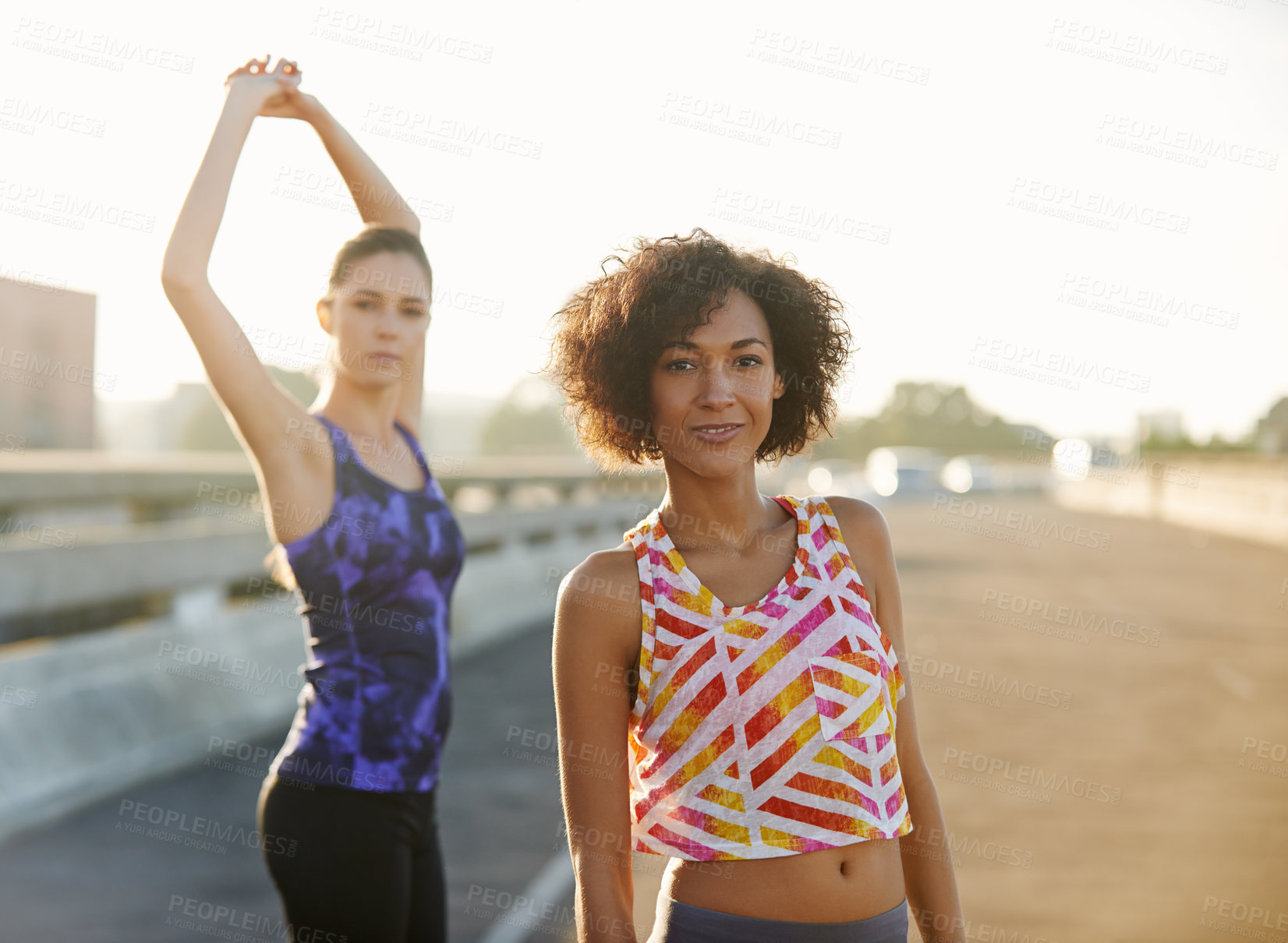 Buy stock photo Portrait of two friends getting ready for a jog together through the city streets