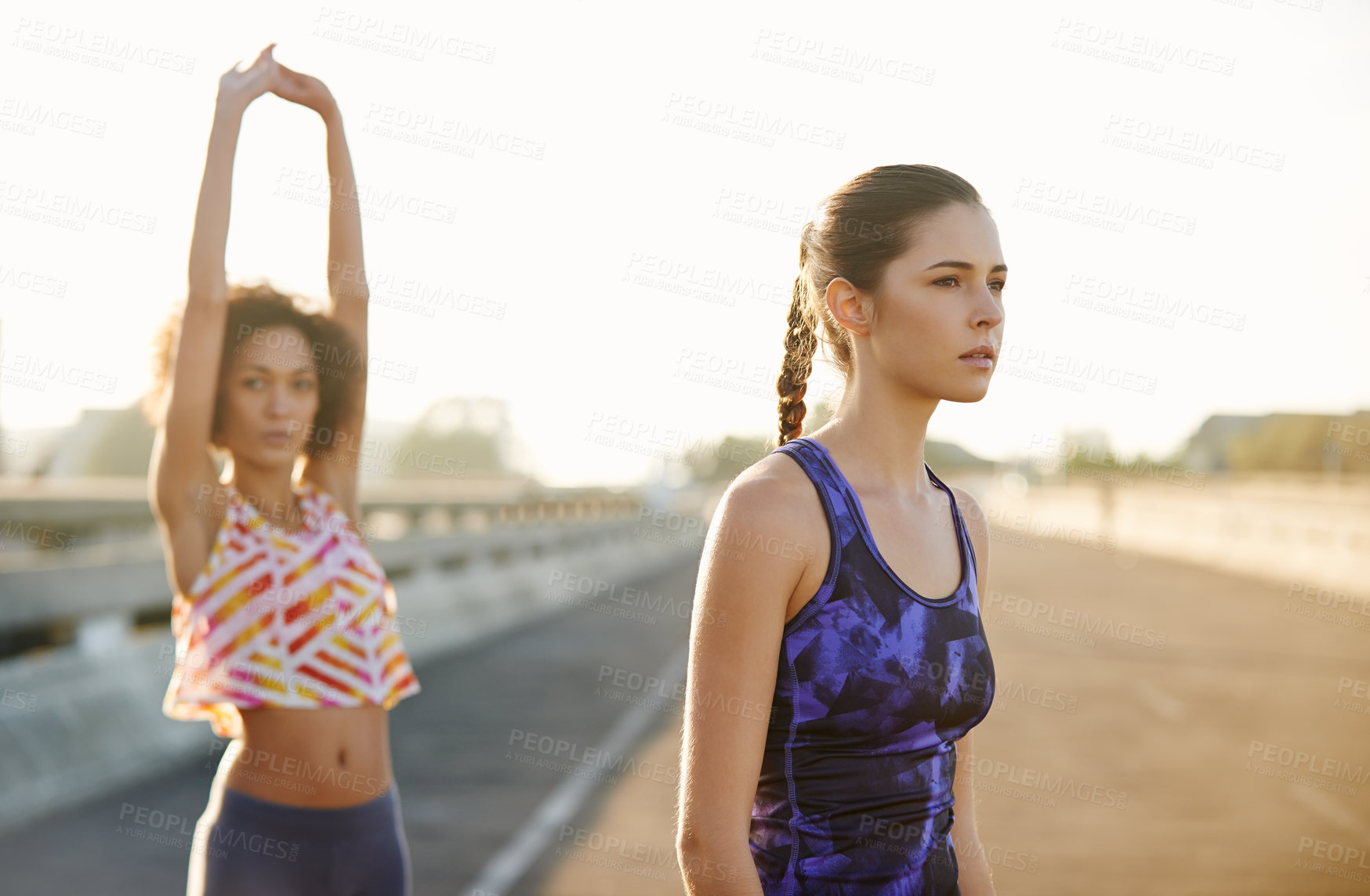 Buy stock photo Woman, road and friends with fitness for stretching, workout or outdoor exercise together in city. Young, active female person or runners in warm up, training or confidence for health and wellness