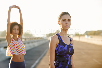 Buy stock photo Portrait of two friends getting ready for a jog together through the city streets