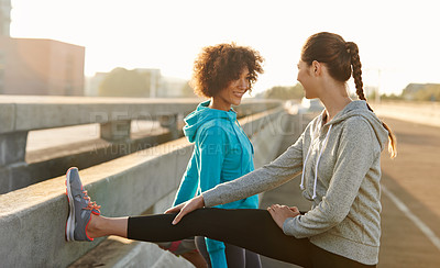 Buy stock photo Women, fitness and stretching with leg on road for workout preparation, training or outdoor exercise. Young, female person or runners in warm up or getting ready for run or cardio in an urban town