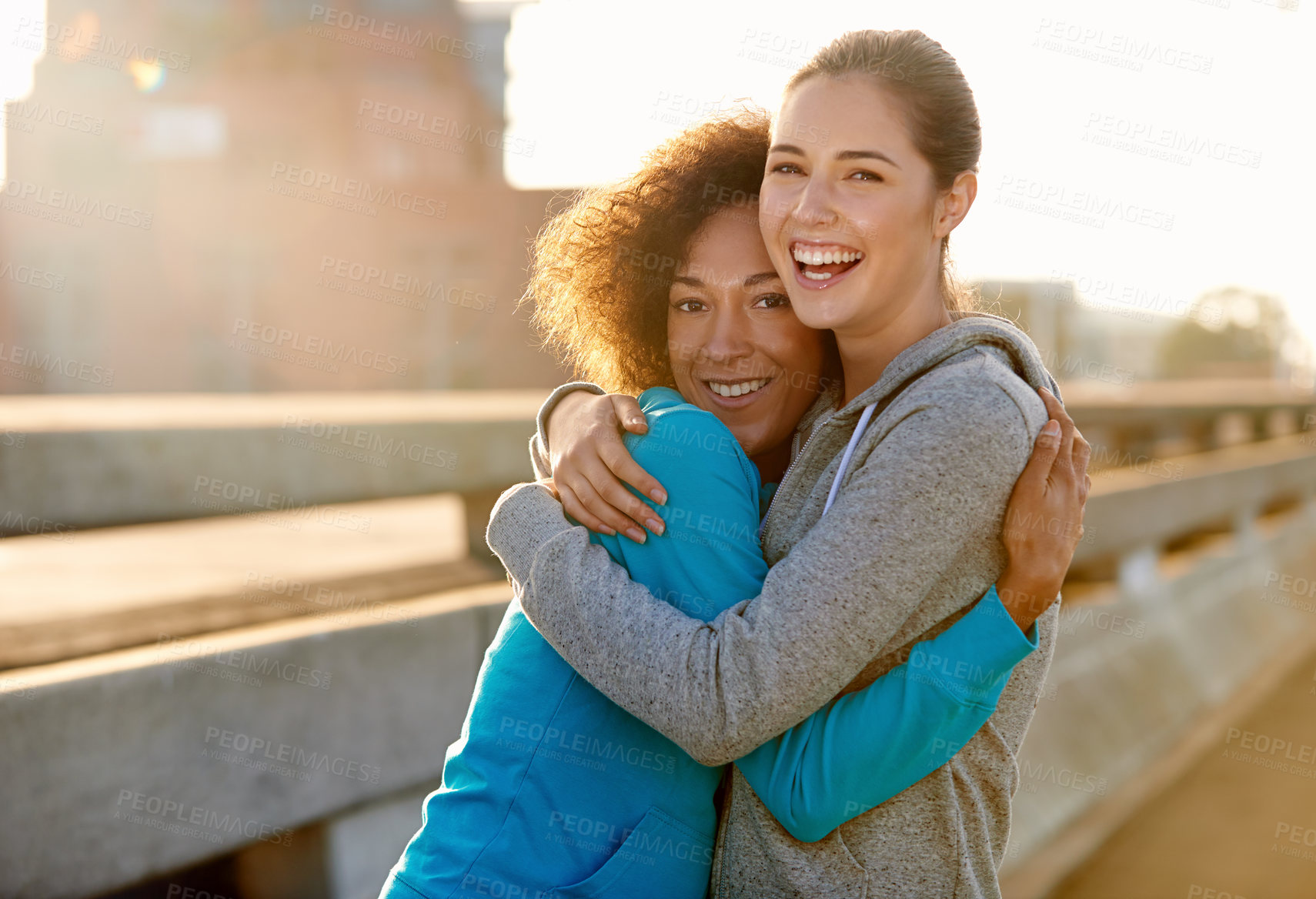 Buy stock photo Women, portrait and hug in city for fitness, exercise and running session for marathon challenge outdoor. Sunshine, people and friends with embrace for wellness goals, support and bonding together