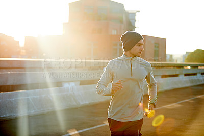 Buy stock photo Man, runner and sunrise in road, training and outdoor for fitness, exercise and health in morning. Person, bridge and direction on metro street at dawn for workout, progress and prepare for marathon