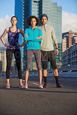 Buy stock photo Fitness, portrait and group of athletes in city for running with race, marathon or endurance training. Sports, serious and team of people in town street for cardio workout, exercise or challenge.