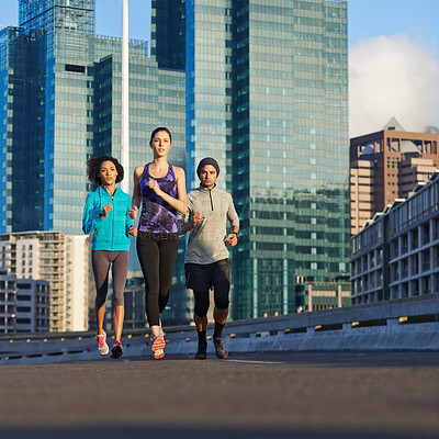 Buy stock photo Urban, road and people running together for fitness, morning training or commitment to healthy body. City, exercise and group of friends on street for workout, outdoor challenge or sports performance