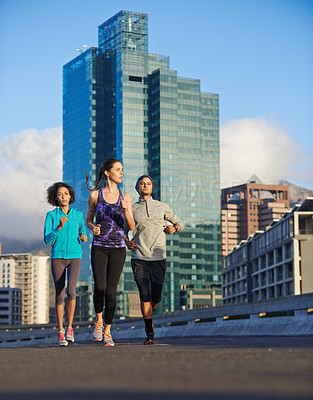 Buy stock photo Fitness, people and running with street in city for workout, training or outdoor exercise together. Young, group or runners in warm up for run, cardio or practice on street in health and wellness