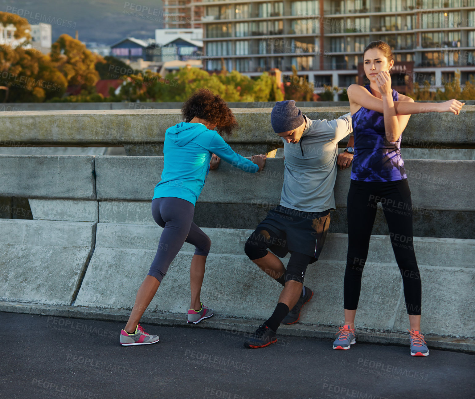 Buy stock photo Fitness, people and stretching with street in city for workout, training or outdoor exercise together. Young, group or runners in warm up for run, cardio or practice on road in health and wellness