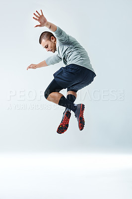 Buy stock photo Side view of a young man jumping against a gray background