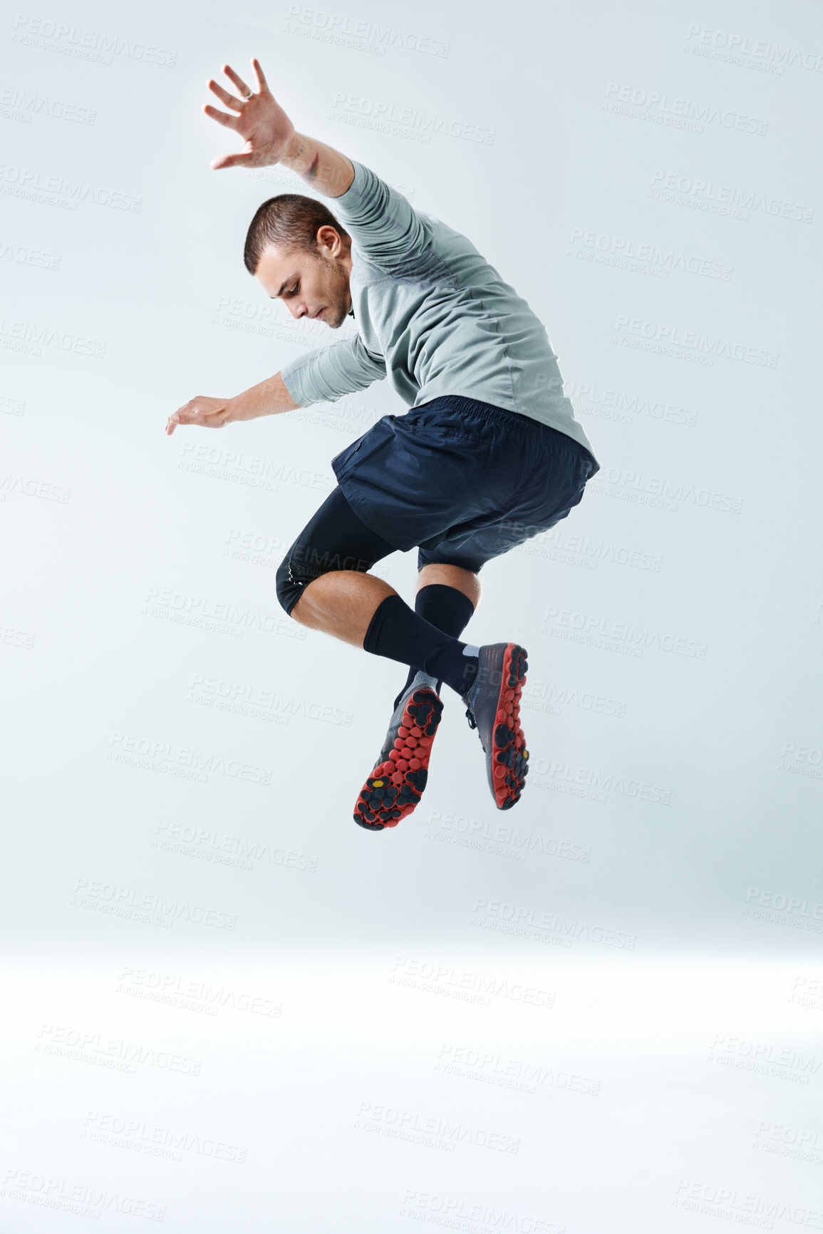 Buy stock photo Fitness, man and jump with workout in studio for healthy body, exercise and muscle strength. Athlete, sports and person in air by white background for performance, challenge or training for self care