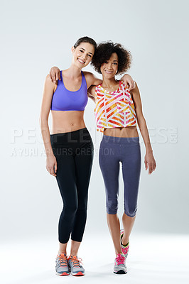 Buy stock photo Two beautiful young women smiling at the camera in sports clothing