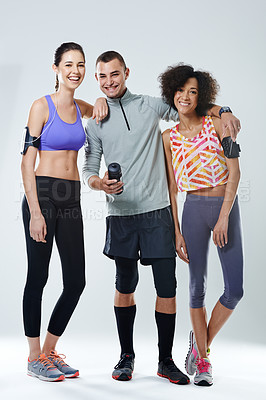 Buy stock photo Portrait of three young adults wearing sports clothing in studio