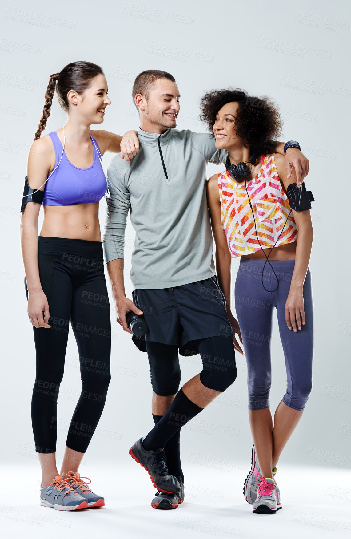 Buy stock photo Shot of three young adults wearing sports clothing in a studio